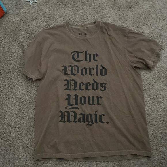 Dressed in LALA Tops - LALA. THE WORLD NEEDS YOUR MAGIC Tee